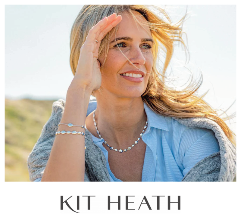 woman looking into the distance wearing a Kit Heath necklace and two stacking bracelets