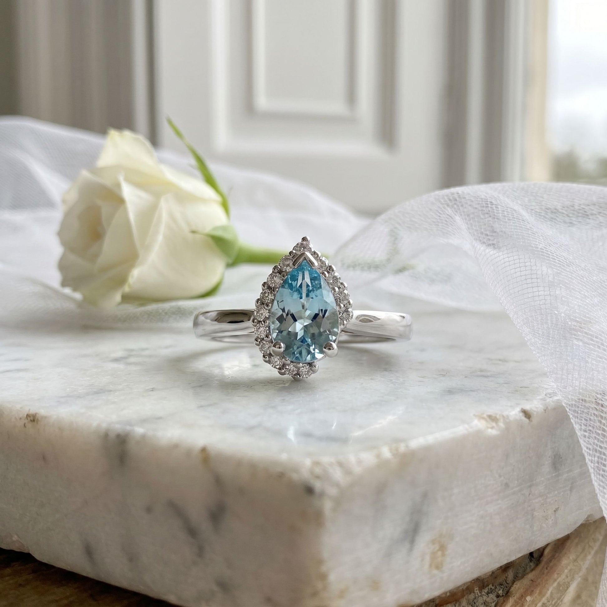 18ct White Gold 0.93ct Pear Shape Aquamarine & Round Diamond Crescent Halo Ring