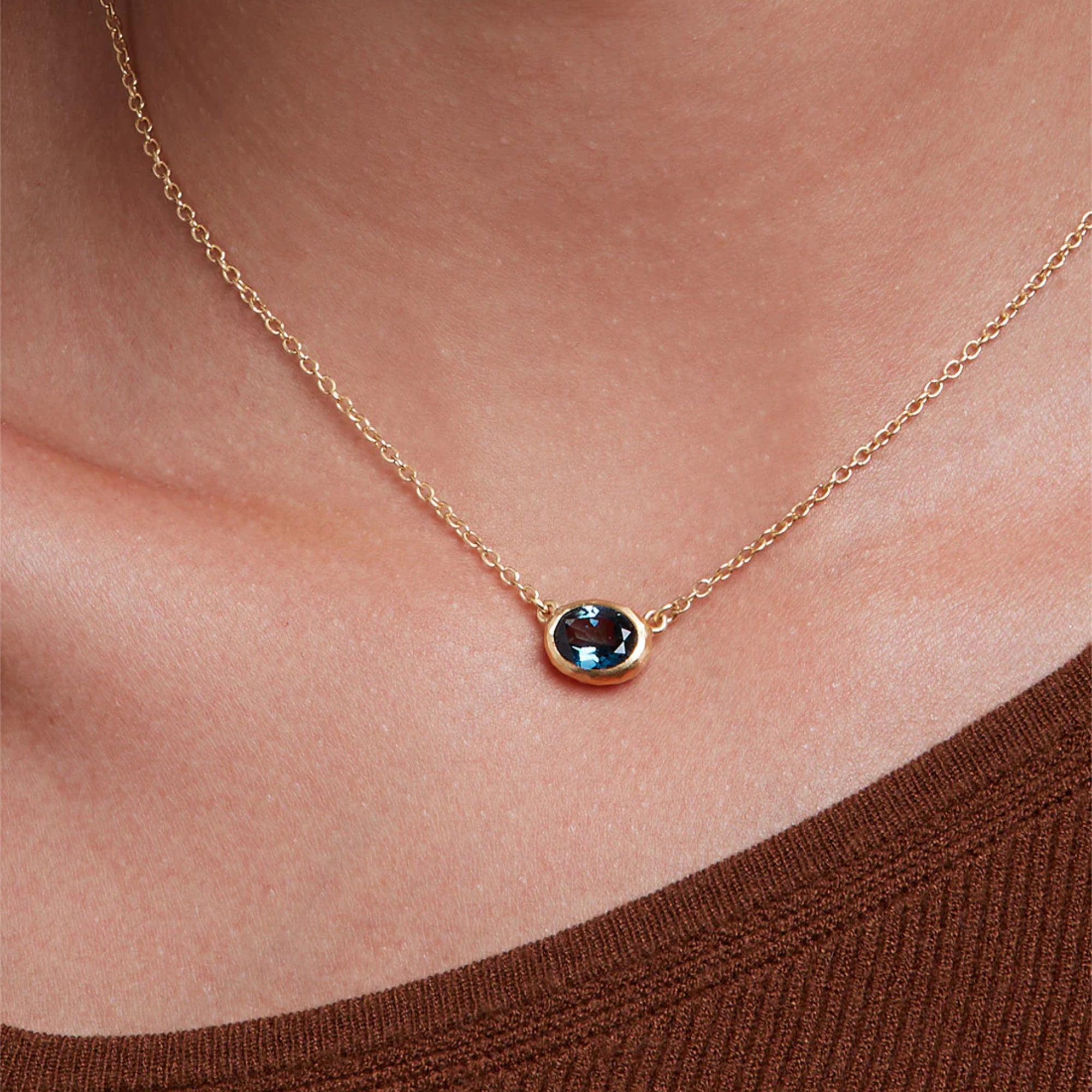 Eloise Gold Plated Sterling Silver Deep Blue Topaz Ellipse Necklace featured on a model - Italian artisan jewellery