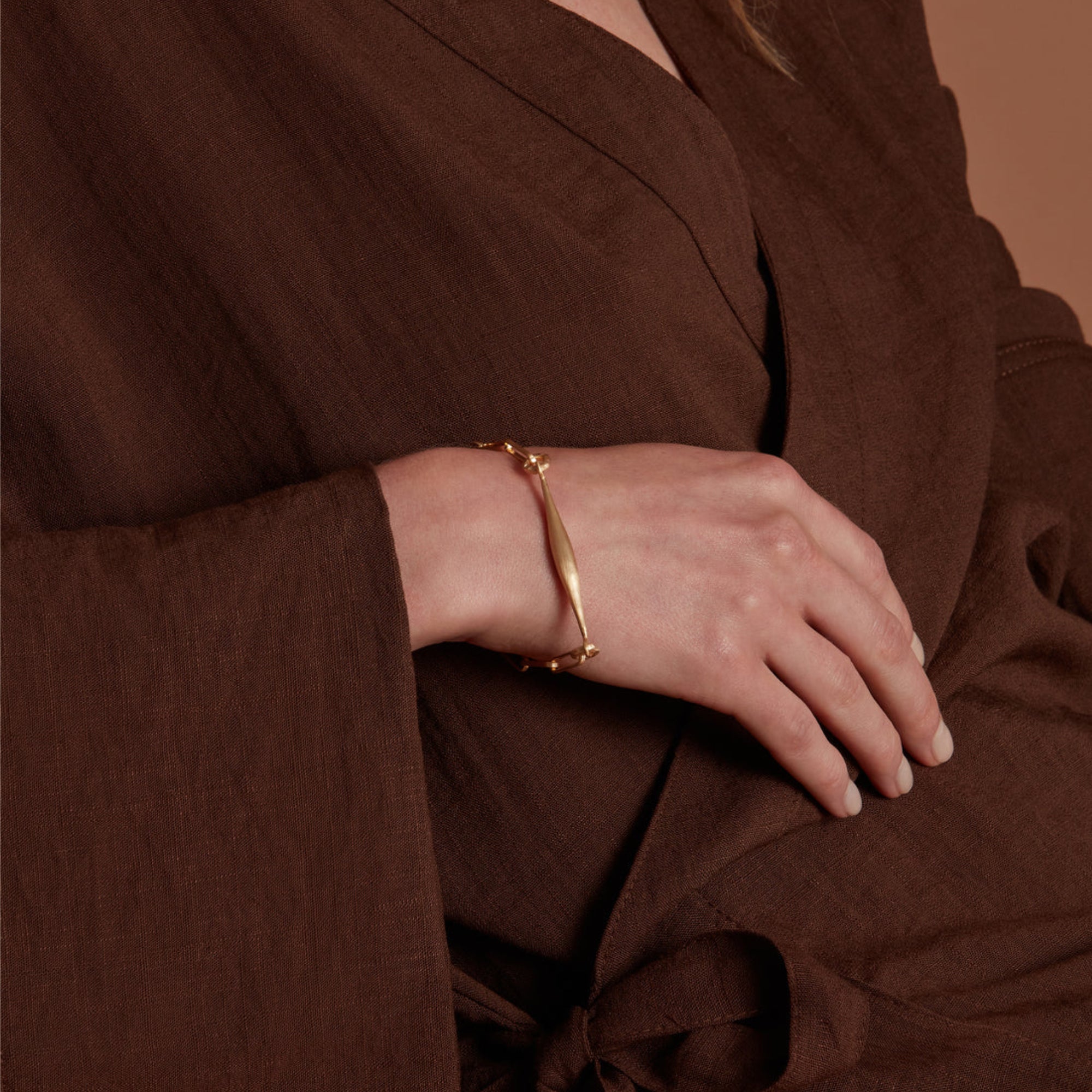 Eloise Gold Plated Sterling Silver Spindle Bracelet featured on a models wrist