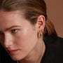 Model Wearing Three Pairs of Eloise Gold Plated Sterling Silver Small  Wander Hoop Earrings