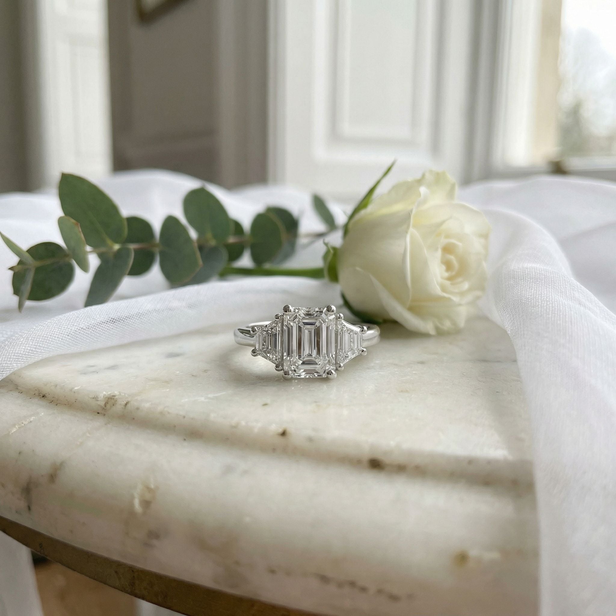 Platinum 1.51ct Emerald Cut Diamond and Trapezoid Diamond Three Stone Ring