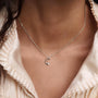 Model wearing PDPAOLA sterling silver initial E necklace with cz