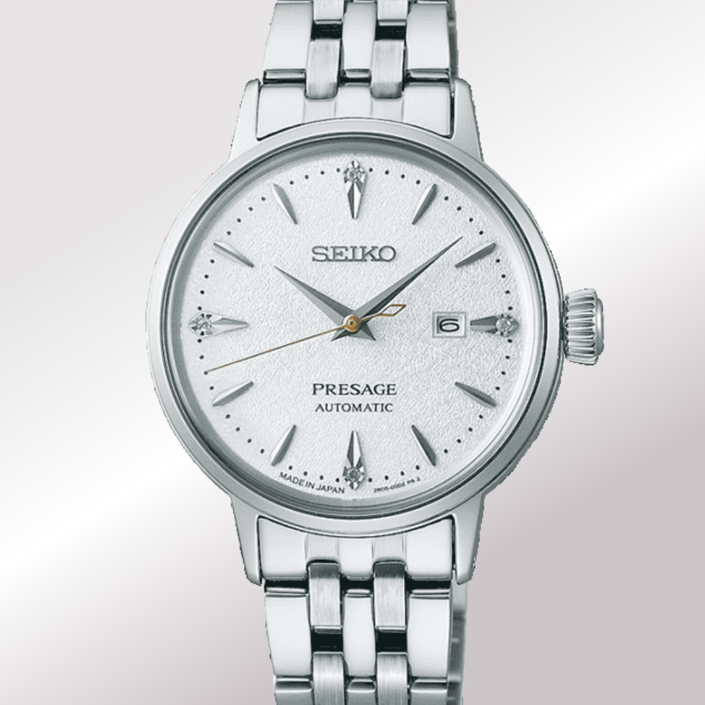 A Seiko Presage Automatic ladies watch with a silver stainless steel case and link bracelet, featuring a textured white dial with silver-tone hour markers and hands.