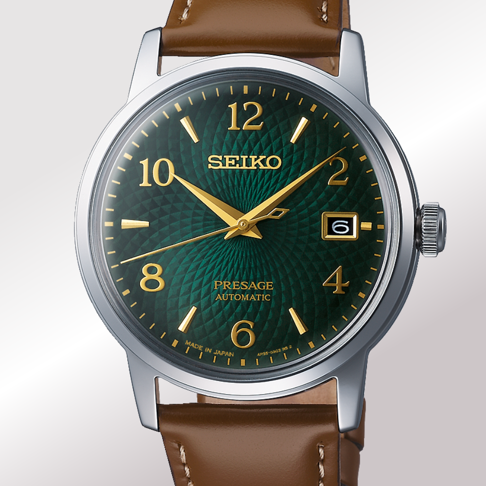 A Seiko Presage mojito Automatic watch with a textured dark green dial, gold-tone hands and markers, and a brown leather strap, shown against a light gray gradient background.