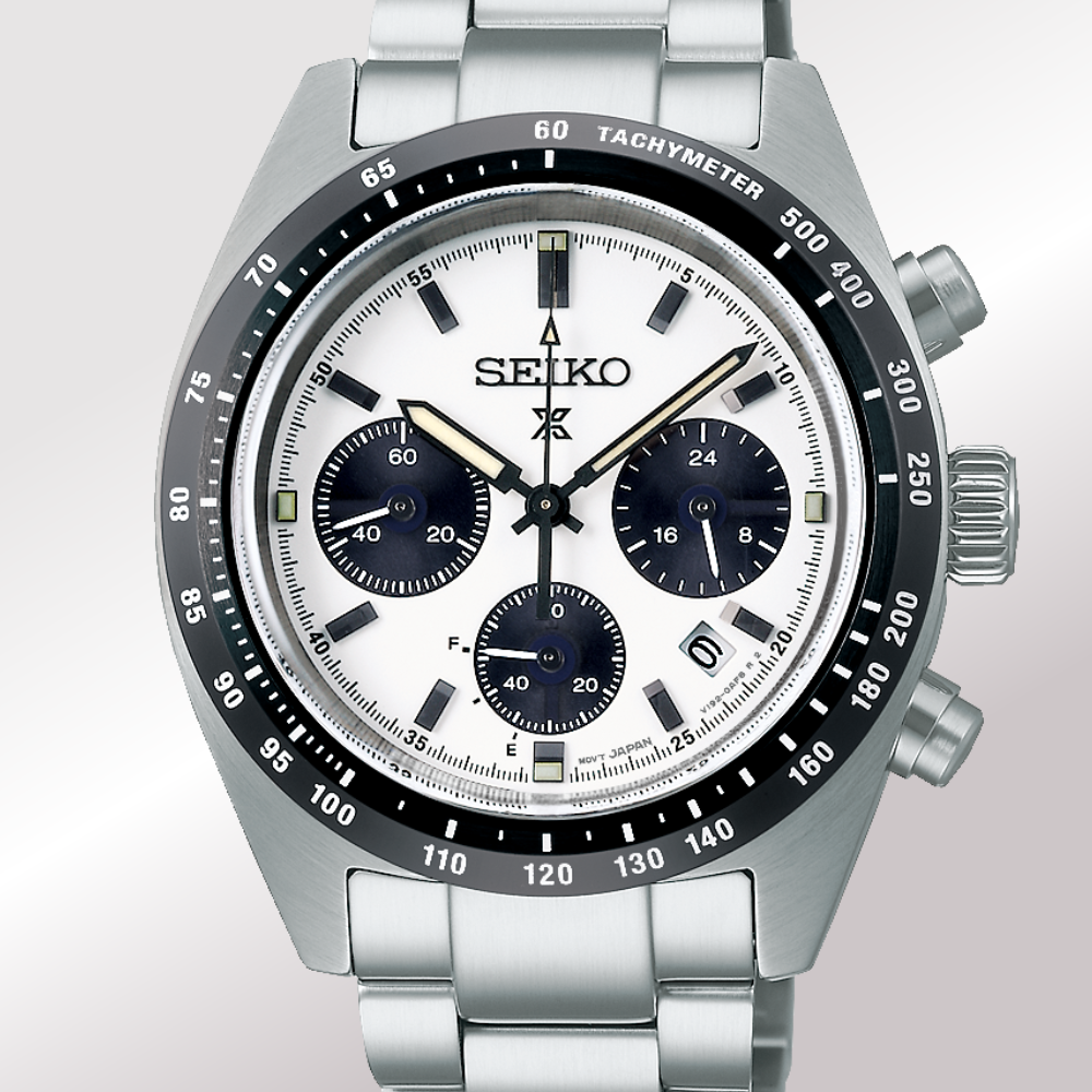 A Seiko prospex stainless steel chronograph watch with a silver-tone metal bracelet, a white dial, and a black tachymeter bezel.